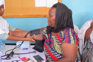 Woman having blood pressure measured in Tanzania